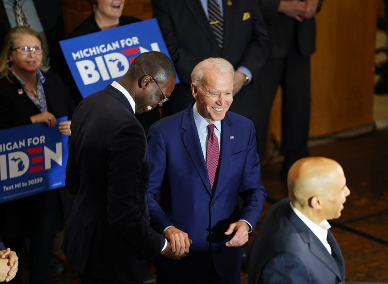 Michigan Lt. Governor Garlin Gilchrist shake the hand of former Vice President Joe Biden after introducing U.S. Sen. Cory Booker to speak while making a campaign stop at Berston Field House in Flint on Monday, March 9, 2020.