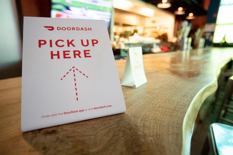 A Door Dash sign sits on the counter Monday, March 16, 2020, 