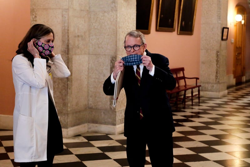 Apr 6, 2020; Columbus, OH, USA; Ohio Gov. Mike DeWine, center, and Dr. Amy Acton, director of the Ohio Department of Health, walk to the state room before a press conference on the State of Ohio's response to the ongoing COVID-19 pandemic on Monday, April