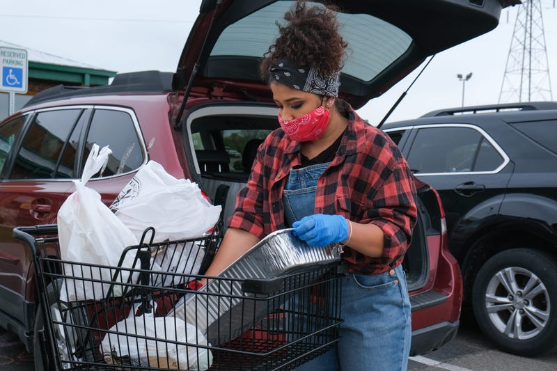 Gianna Prestol loads groceries into a car at the Texas Roadhouse drive-up farmer s market in Milford, Ohio on Sunday, April 19, 2020. Texas Roadhouse Farmers Market6812