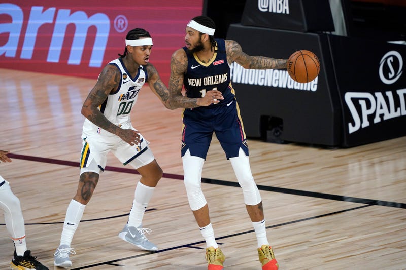 New Orleans Pelicans' Brandon Ingram, right, looks to pass around Utah Jazz's Jordan Clarkson (00) during the first half of an NBA basketball game.