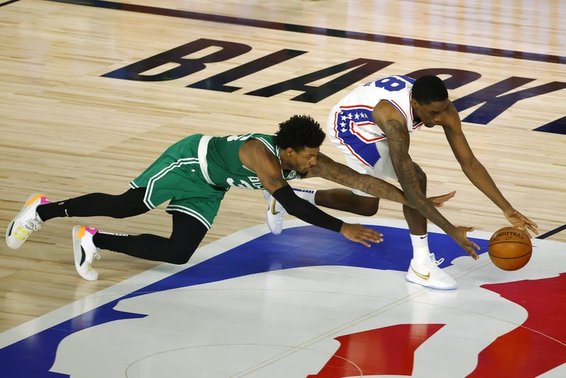 Marcus Smart #36 of the Boston Celtics knocks the ball loose from Shake Milton #18 of the Philadelphia 76ers during the second quarter in game two of the first round of the 2020 NBA Playoffs at The Field House.