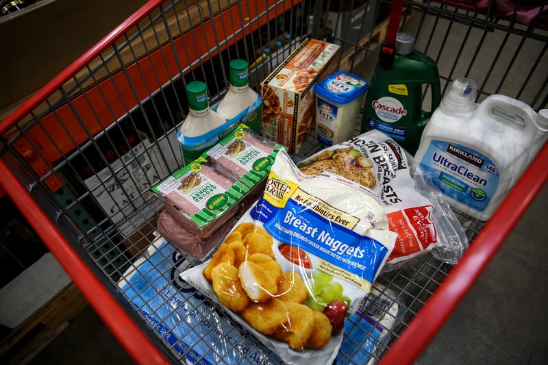 Luke Clifton fills a shopping cart from a list given to him by a family using the PDX Deliver service on Wednesday, Aug. 19, 2020 at Costco in Salem, Oregon. Grocerydelivery002