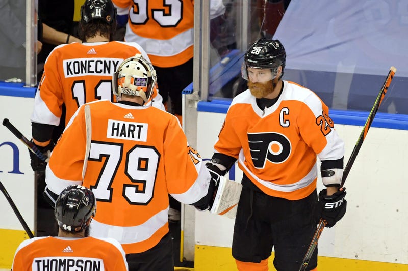 Philadelphia Flyers left wing Claude Giroux (28) shakes hands with goaltender Carter Hart (79) after their win over the New York Islanders.