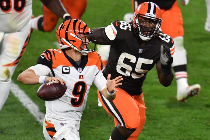 Sep 17, 2020; Cleveland, Ohio, USA; Cleveland Browns defensive tackle Larry Ogunjobi (65) chases Cincinnati Bengals quarterback Joe Burrow (9) during the second half at FirstEnergy Stadium. Mandatory Credit: Ken Blaze-USA TODAY Sports