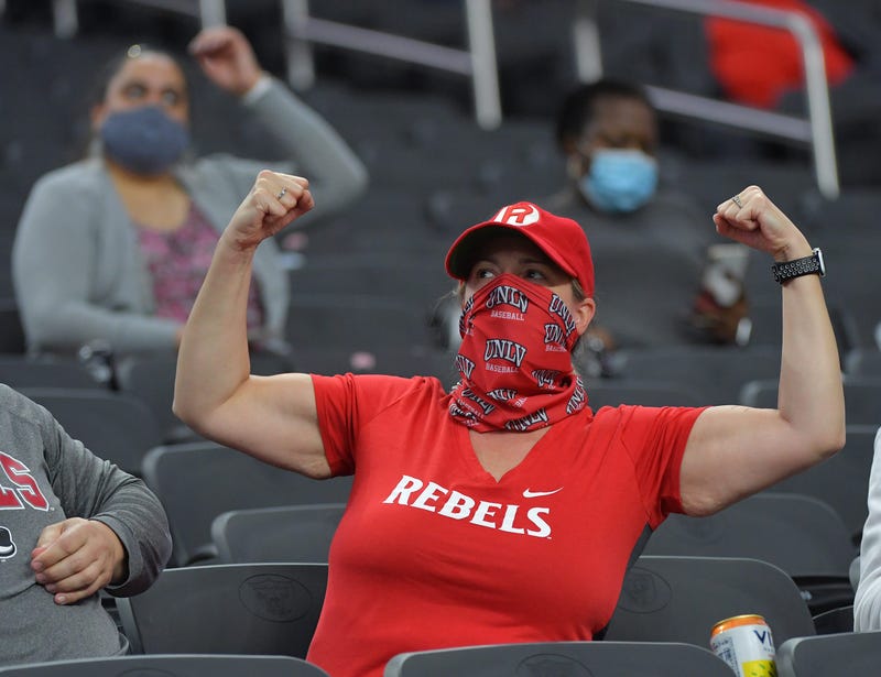 A UNLV Rebels fan flexes for the camera during a time out between the UNLV Rebels and the Fresno Bulldogs at Allegiant Stadium.
