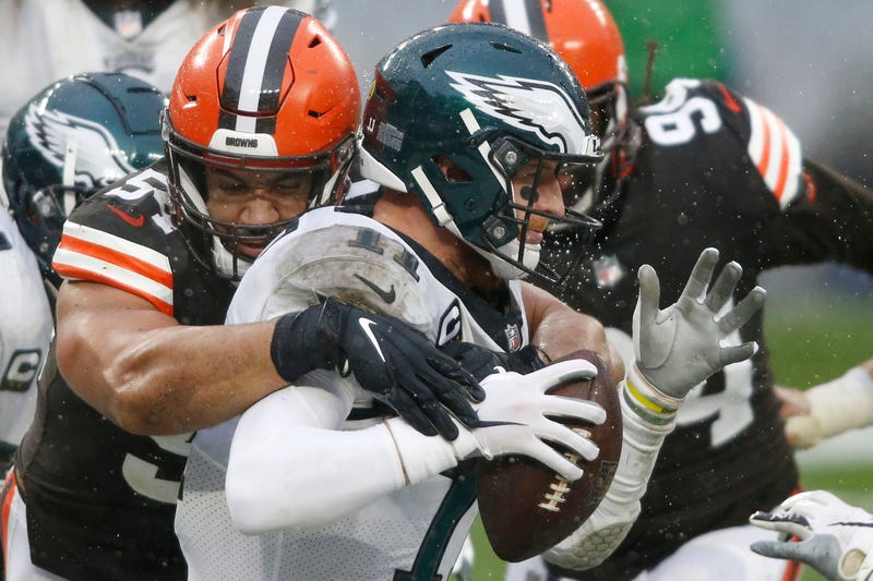Nov 22, 2020; Cleveland, Ohio, USA; Cleveland Browns defensive end Olivier Vernon (54) sacks Philadelphia Eagles quarterback Carson Wentz (11) for a safety during the second half at FirstEnergy Stadium. Mandatory Credit: Scott Galvin-USA TODAY Sports