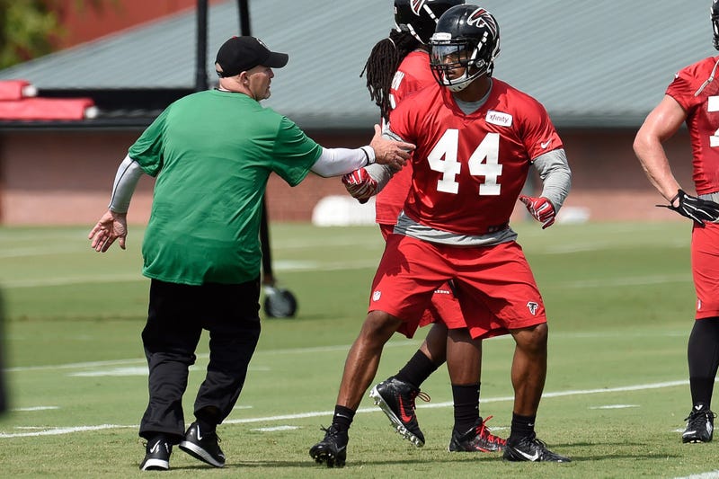 Aug 1, 2015; Atlanta, GA, USA; Atlanta Falcons head coach Dan Quinn works with defensive end Vic Beasley (44) on the field during training camp at the Flowery Branch Training Facility. Mandatory Credit: Dale Zanine-USA TODAY Sports