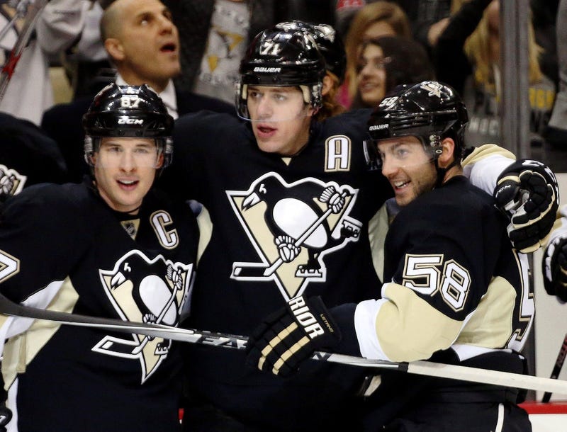 Pittsburgh Penguins center Sidney Crosby (87) and center Evgeni Malkin (71) and defenseman Kris Letang (58) celebrate after a gaol by Malkin against the Vancouver Canucks during the second period at the CONSOL Energy Center. 