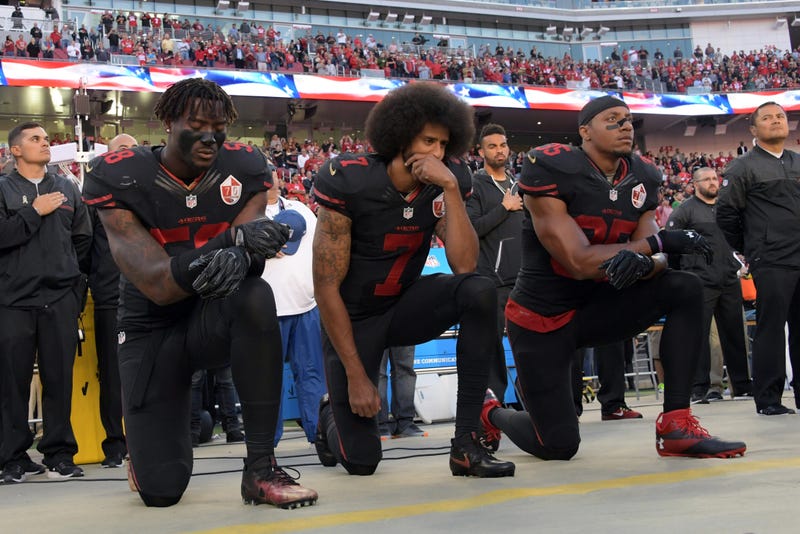 San Francisco 49ers outside linebacker Eli Harold (58), quarterback Colin Kaepernick (7) and free safety Eric Reid (35) kneel in protest during the playing of the national anthem before a NFL game