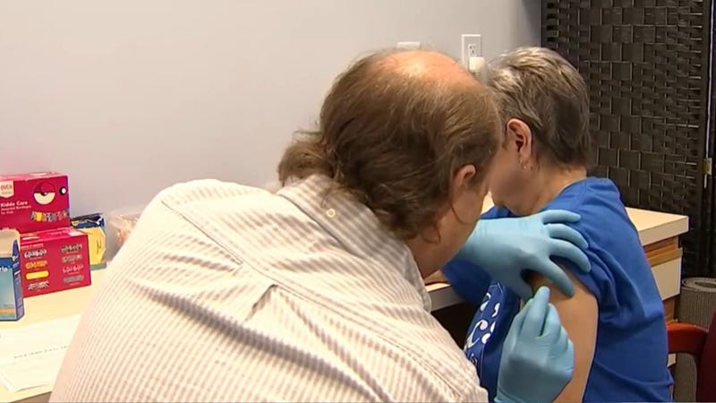 Joanne Vanett (right) receives her RSV vaccine at Eric's RX Shoppe in Horsham, Pa.