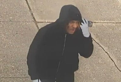 surveillance image of man talking on phone