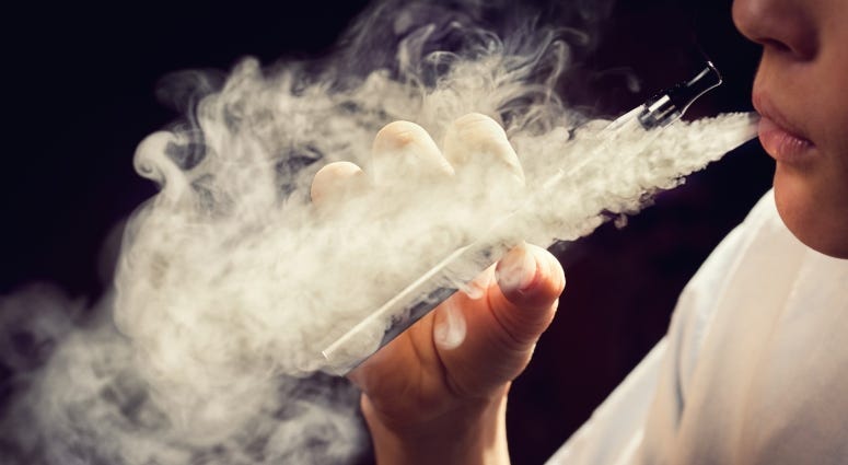 teen using e-cigarette vaporizer