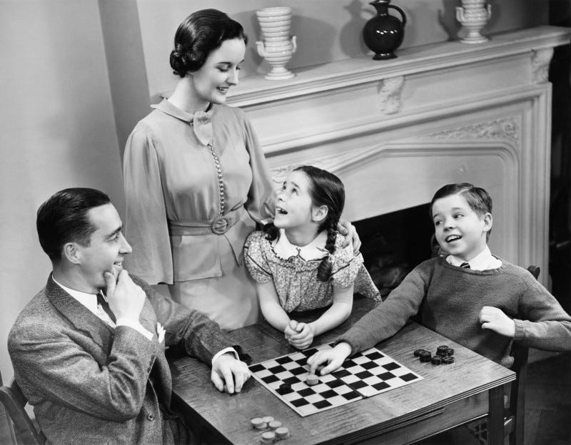 Old-fashioned family playing checkers