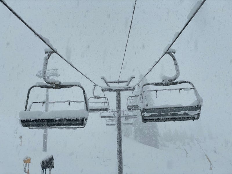 Chair lifts collect fresh snow as an atmospheric river storm passes through Northern California.