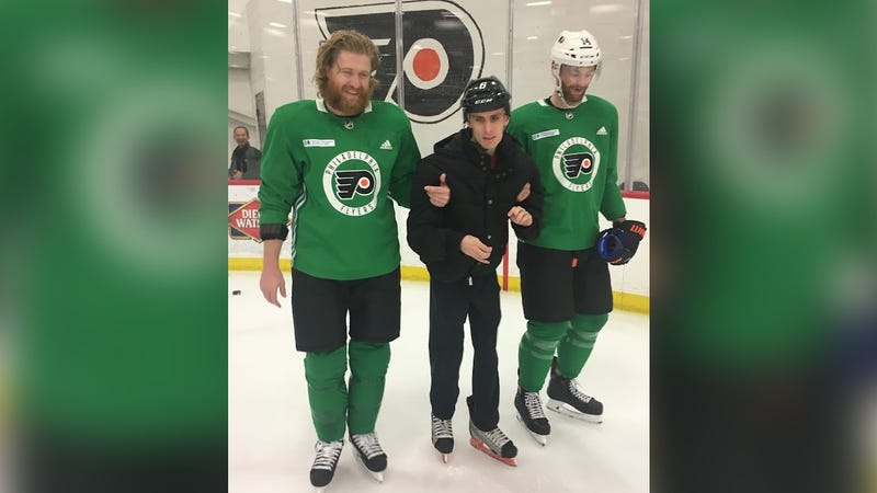 Jakub Voráček and Sean Couturier with a fan at a 2019 "try hockey" event.