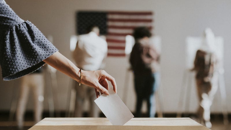American casting her vote to a ballot box - stock photo