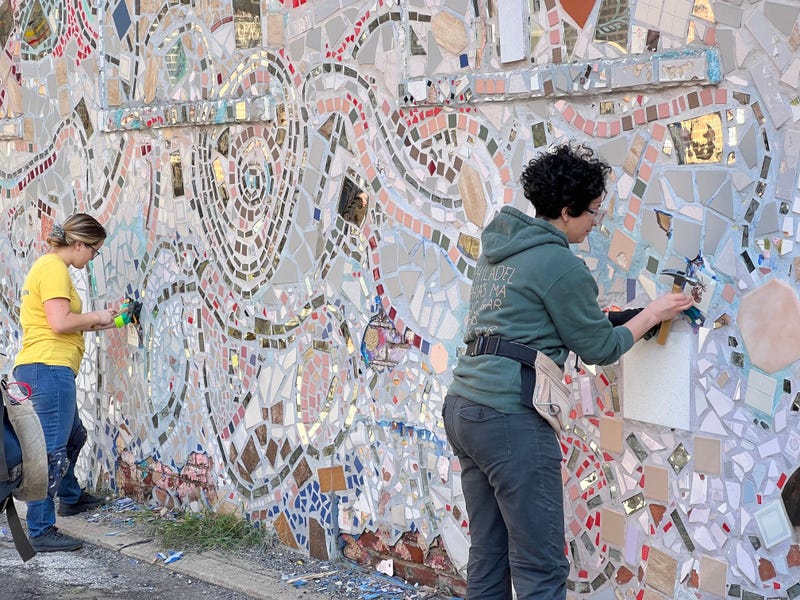 Workers remove the tiles from the walls of the Painted Bride Art Center.