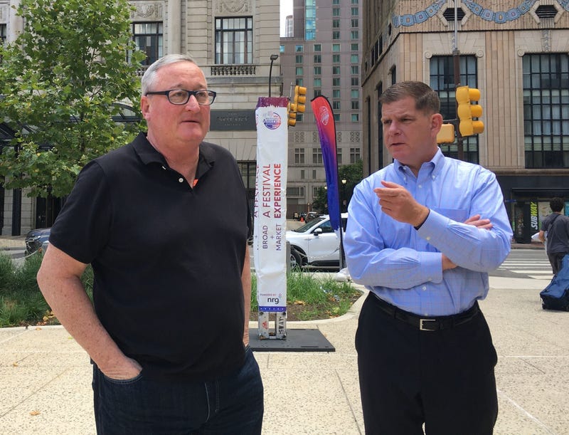 U.S. Secretary of Labor Marty Walsh (right) confers with Philadelphia Mayor Jim Kenney Saturday.
