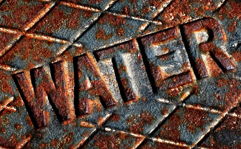 Detail of iron water cover man hole rusty lid