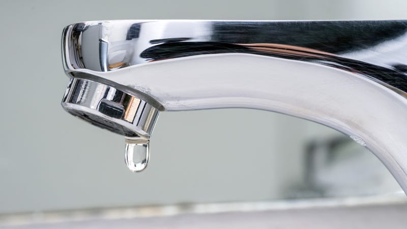 Drop of water falling from faucet - stock photo