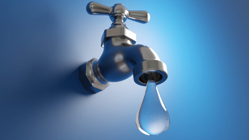 A silver water faucet dripping a large water droplet on blue background