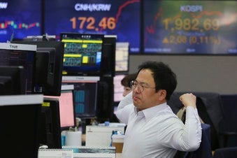 A currency trader watches monitors at the foreign exchange dealing room of the KEB Hana Bank headquarters in Seoul, South Korea, Wednesday, May 20, 2020. (AP Photo/Ahn Young-joon)
