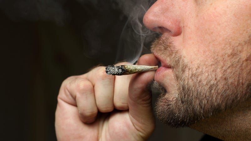 A shot of a man smoking pot.