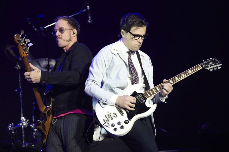 Scott Shriner and Rivers Cuomo of Weezer perform onstage during KROQ Almost Acoustic Christmas 2017 
