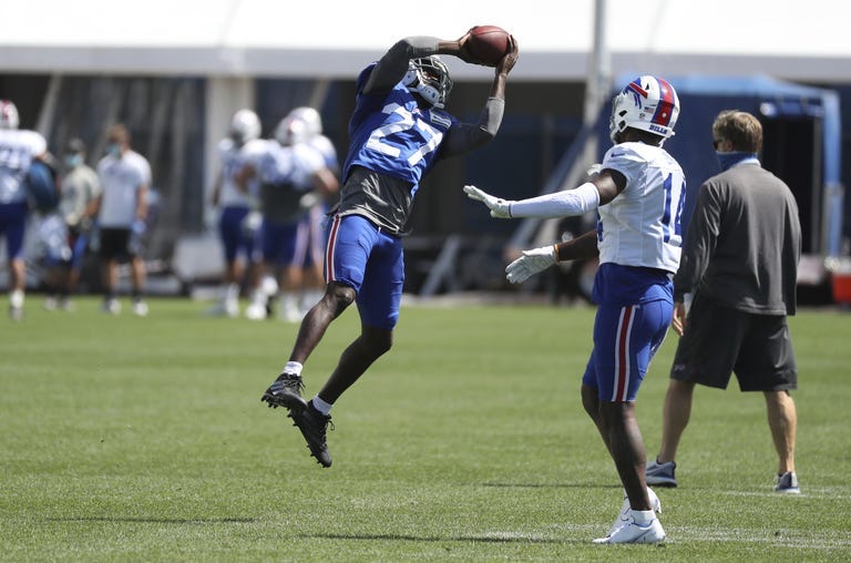 Buffalo Bills cornerback Tre’Davious White (27) intercepts the ball in front of wide receiver Stefon Diggs (14) during... (James P. McCoy/Buffalo News via AP, Pool)