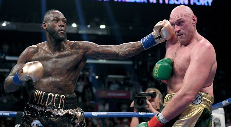 Deontay Wilder punches Tyson Fury in the ninth round fighting to a draw during the WBC heavyweight championship at Staples Center on Dec. 1, 2018 in Los Angeles, California.