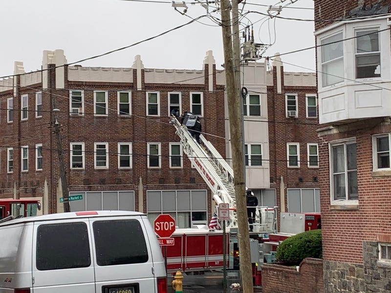 Wilmington police used a fire ladder to rescue a woman and a child from a third-story window in a building near where three officers were shot Wednesday night.