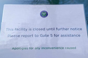 A signs outside one of the main gates to Wimbledon as it is announced the the Wimbledon tennis Championships for 2020 has bee. n cancelled due to the coronavirus in London. (AP Photo/Kirsty Wigglesworth)