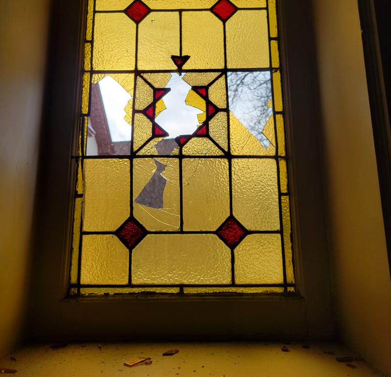 window damaged at church with glass shards