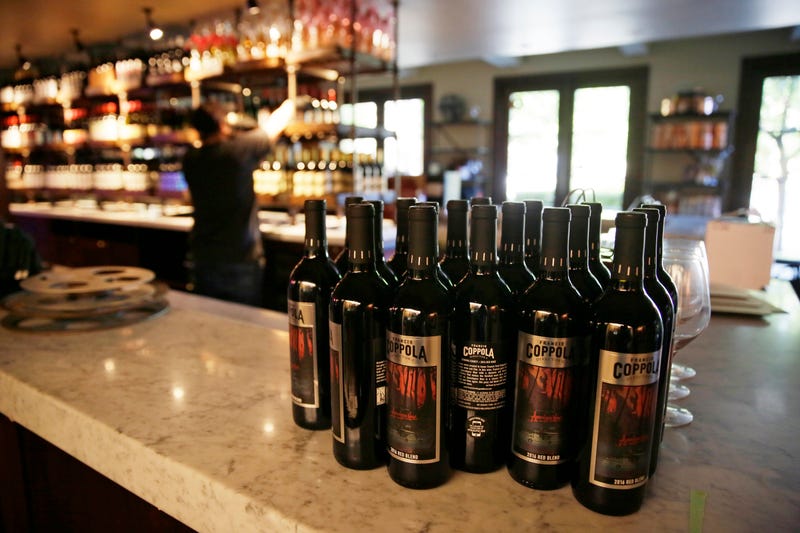 FILE - Bottles of Apocalypse Now Red Blend wine stand on a tasting bar counter at the Francis Ford Coppola Winery on May 21, 2020, in Geyserville, Calif. The California Legislature approved a measure Wednesday, Aug. 31, 2022, that would add wine and distilled spirits containers to the state's recycling program, sending it to Gov. Gavin Newsom.