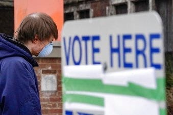 FILE - In this April 7, 2020, file photo voters line up at Riverside High School for Wisconsin's primary election in Milwaukee. (AP Photo/Morry Gash, File)