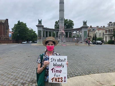 Cathy Springston holds a sign in front of the Jefferson Davis Monument on June 11, 2020. (Matt Demlein, WRVA)