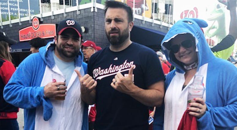 106.7 The Fan's Danny Rouhier and fans dressed as "baby shark" pose before Game 5 of the World Series at Nationals Park on Sunday, October 27.
