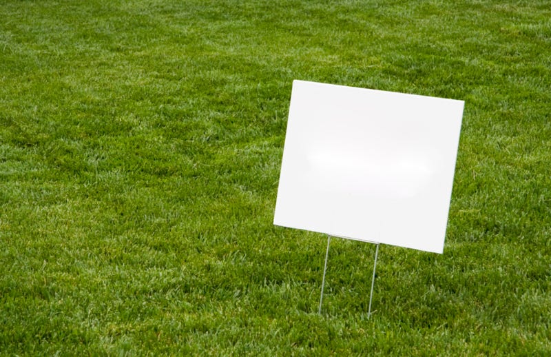 Blank white sign on newly cut grass