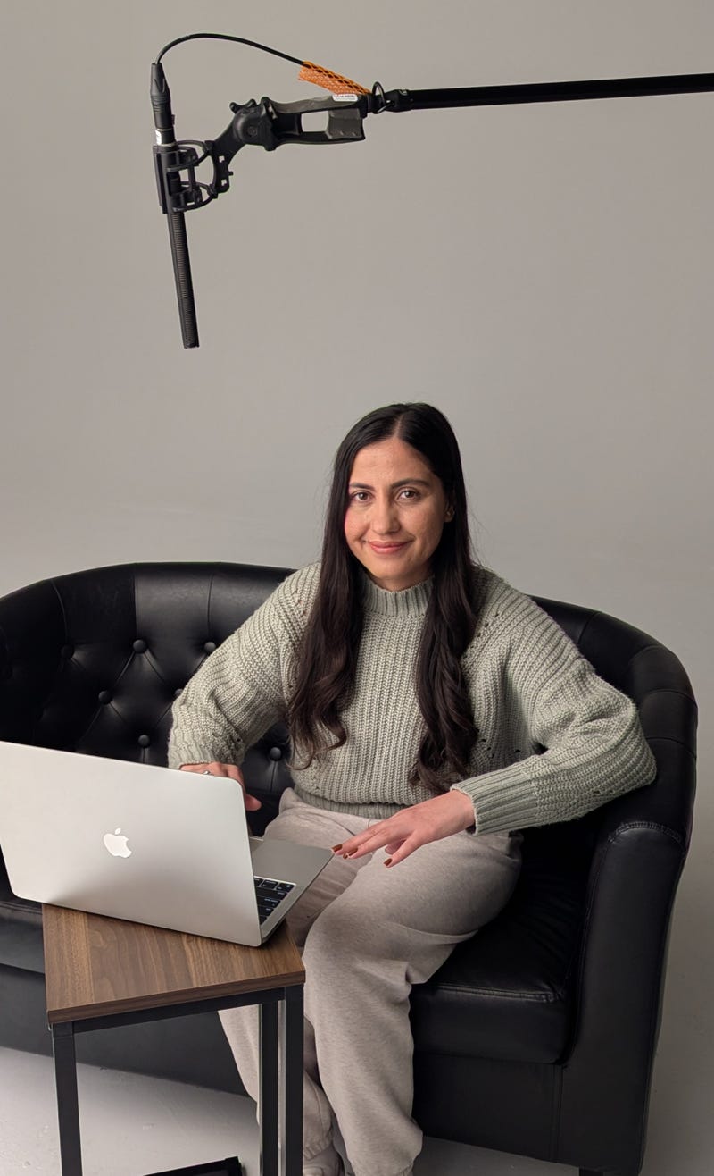 ZZ sits at a computer on the set of Queen of the Base preparing to speak with family members in Afghanistan who are still in hiding.