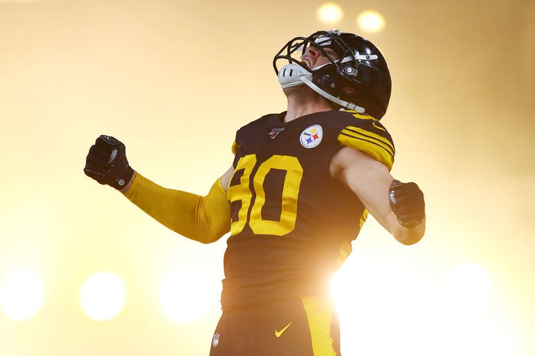 T.J. Watt #90 of the Pittsburgh Steelers jumps in the air as he runs onto the field before a game