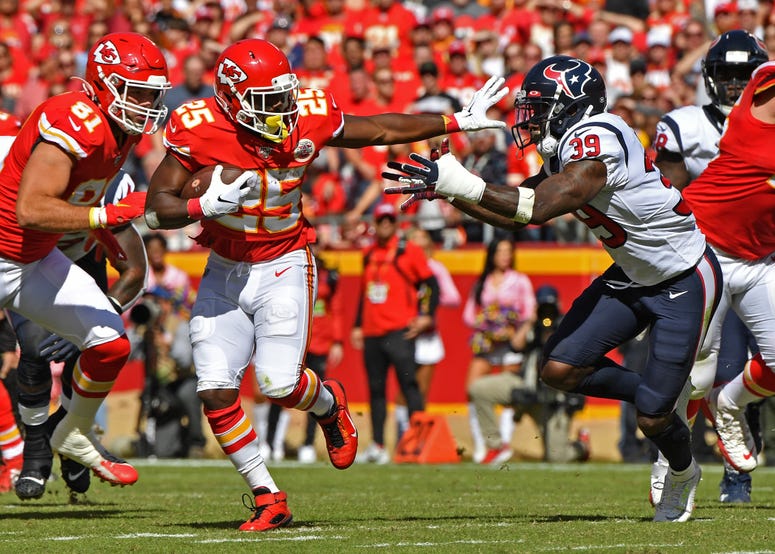  Running back LeSean McCoy #25 of the Kansas City Chiefs runs up field against pressure from free safety Tashaun Gipson #39 of the Houston Texans during the first half at Arrowhead Stadium on October 13, 2019 in Kansas City, Missouri.