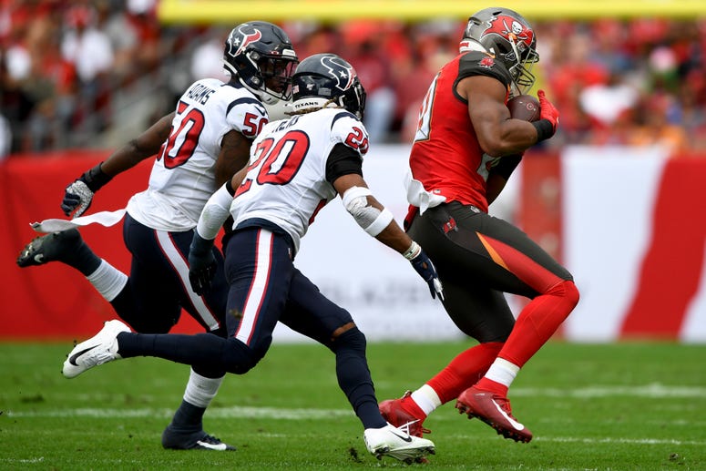 Tampa Bay Buccaneers tight end O.J. Howard (80) makes a reception in front of Houston Texans strong safety Justin Reid (20) and linebacker Tyrell Adams (50) during the first quarter at Raymond James Stadium.