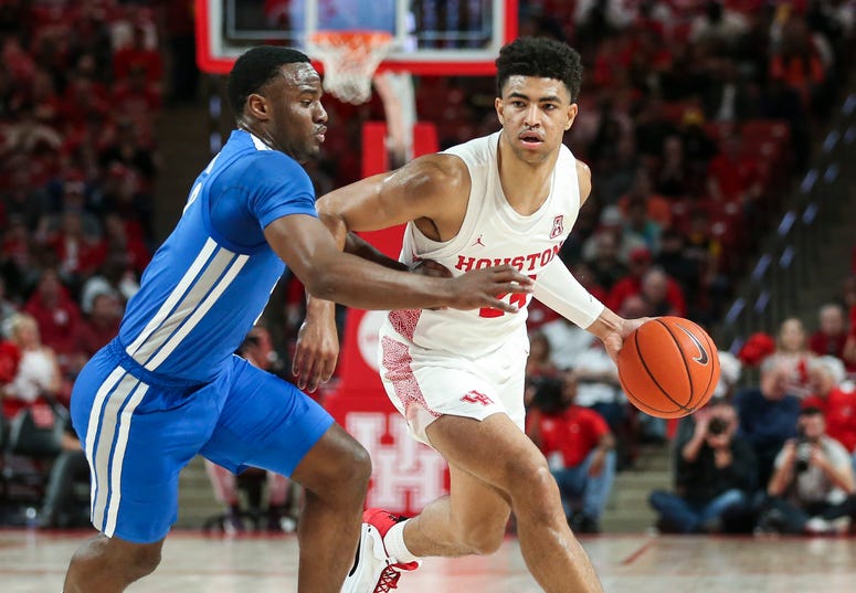 Houston Cougars guard Quentin Grimes (24) dribbles the ball as Memphis Tigers guard Alex Lomax (2) defends during the first half at Fertitta Center.