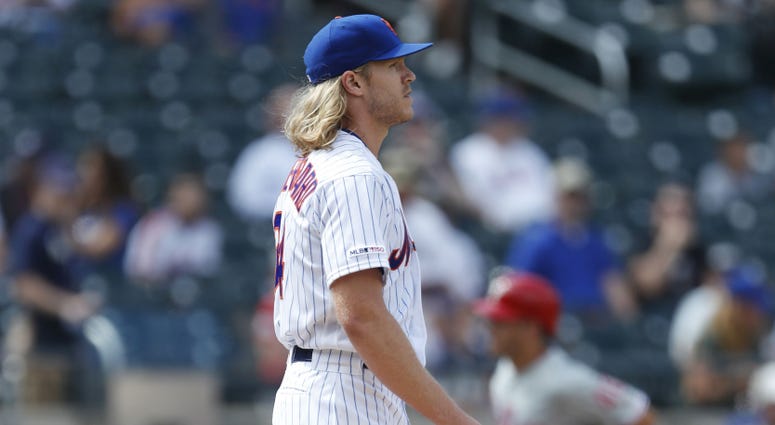 Philadelphia Phillies' Corey Dickerson, right, trots past New York Mets' starting pitcher Noah Syndergaard after hitting a solo home run during the fourth inning of a baseball game, Sunday, Sept. 8, 2019, in New York
