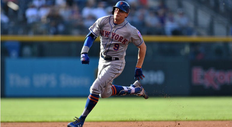 Brandon Nimmo heads to third for an inside the park home run in the first inning against the Colorado Rockies at Coors Field.
