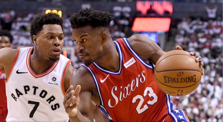 Philadelphia 76ers guard Jimmy Butler dribbles the ball against Toronto Raptors guard Kyle Lowry in game seven of the second round of the 2019 NBA Playoffs. Jimmy Butler