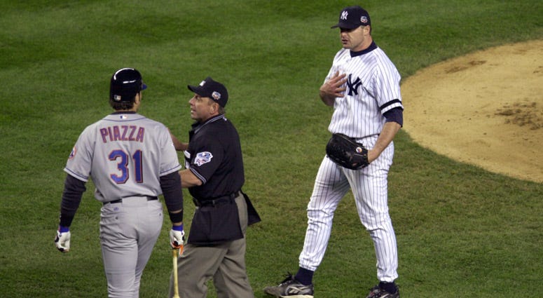 Yankees pitcher Roger Clemens (right) is separated from Mets catcher Mike Piazza (31) after Clemens threw a broken bat toward Piazza during Game 2 of the World Series on Oct. 22, 2000 at Yankee Stadium.