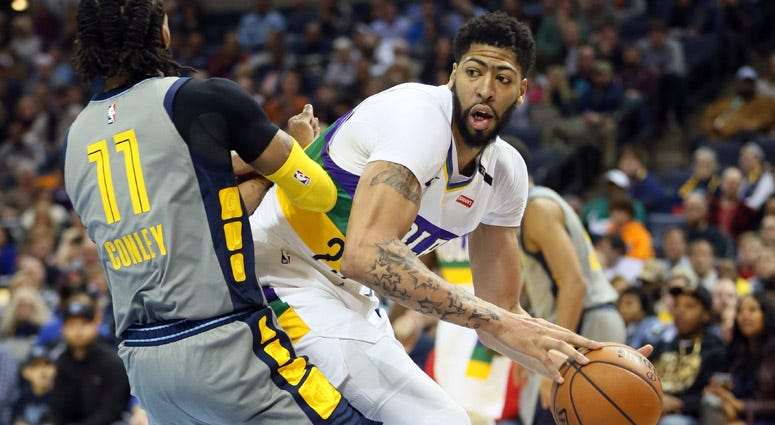 Pelicans forward Anthony Davis looks to pass as Grizzlies guard Mike Conley defends on Feb. 9, 2019, in Memphis.  