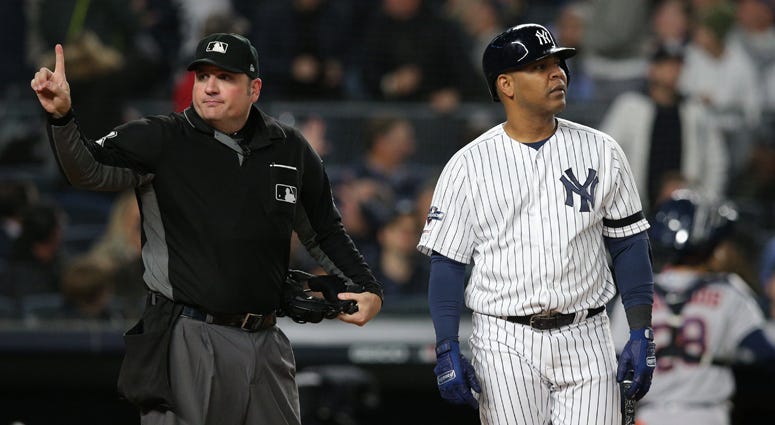 The Yankees' Edwin Encarnacion walks back to the dugout after arguing with home plate umpire Dan Bellino following a strikeout in Game 4 of the ALCS on Oct. 17, 2019, at Yankee Stadium. 
